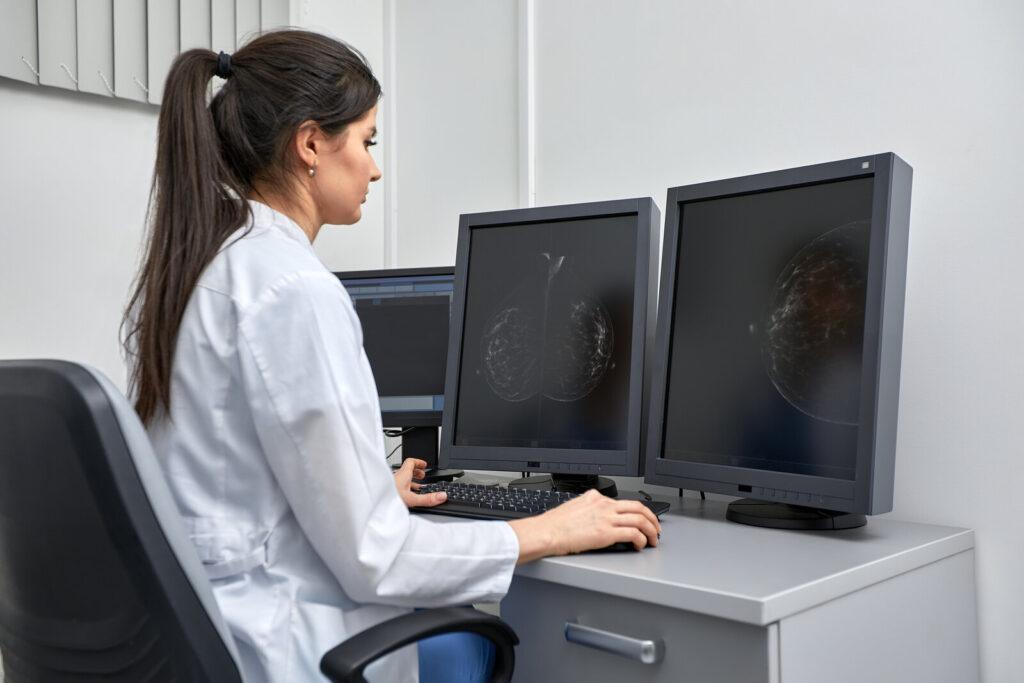 Mammography reading desk Doctor reviewing mammography images on two monitors at a reading desk