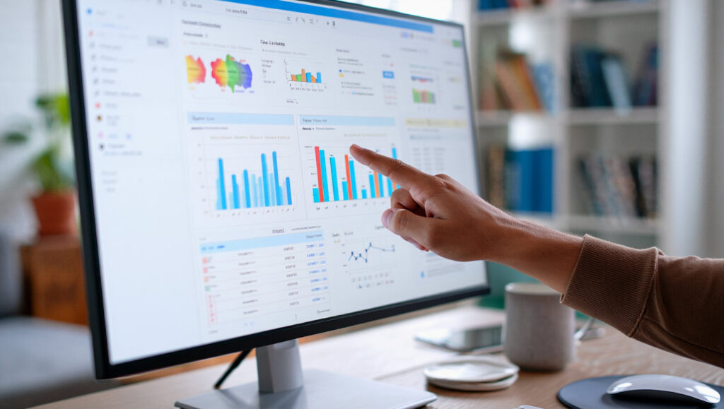 Interactive figures Person pointing at interactive charts on a computer monitor