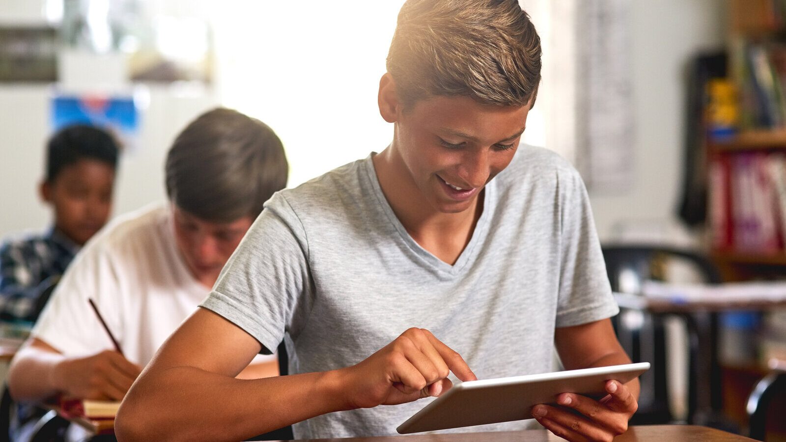 High school student working on a tablet during class