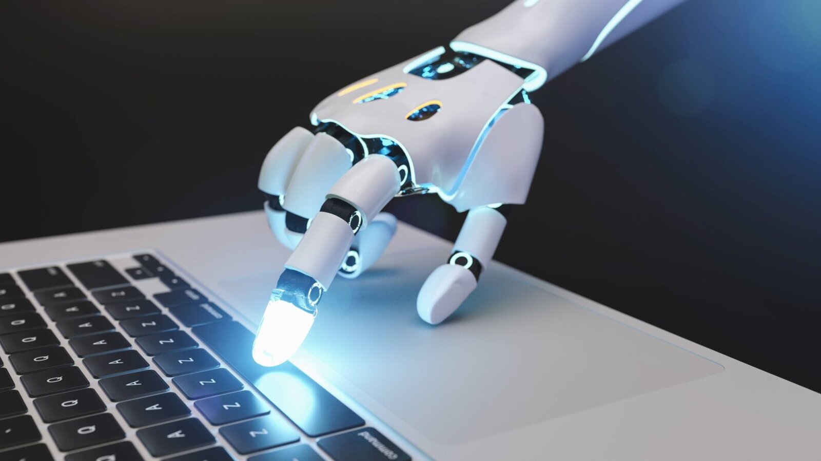 Robotic hand pressing a key on a laptop keyboard