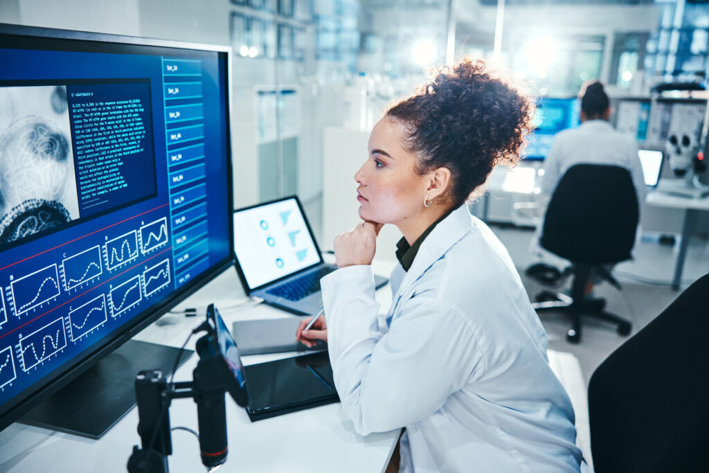 Computational research Scientist working at a computer in a modern laboratory
