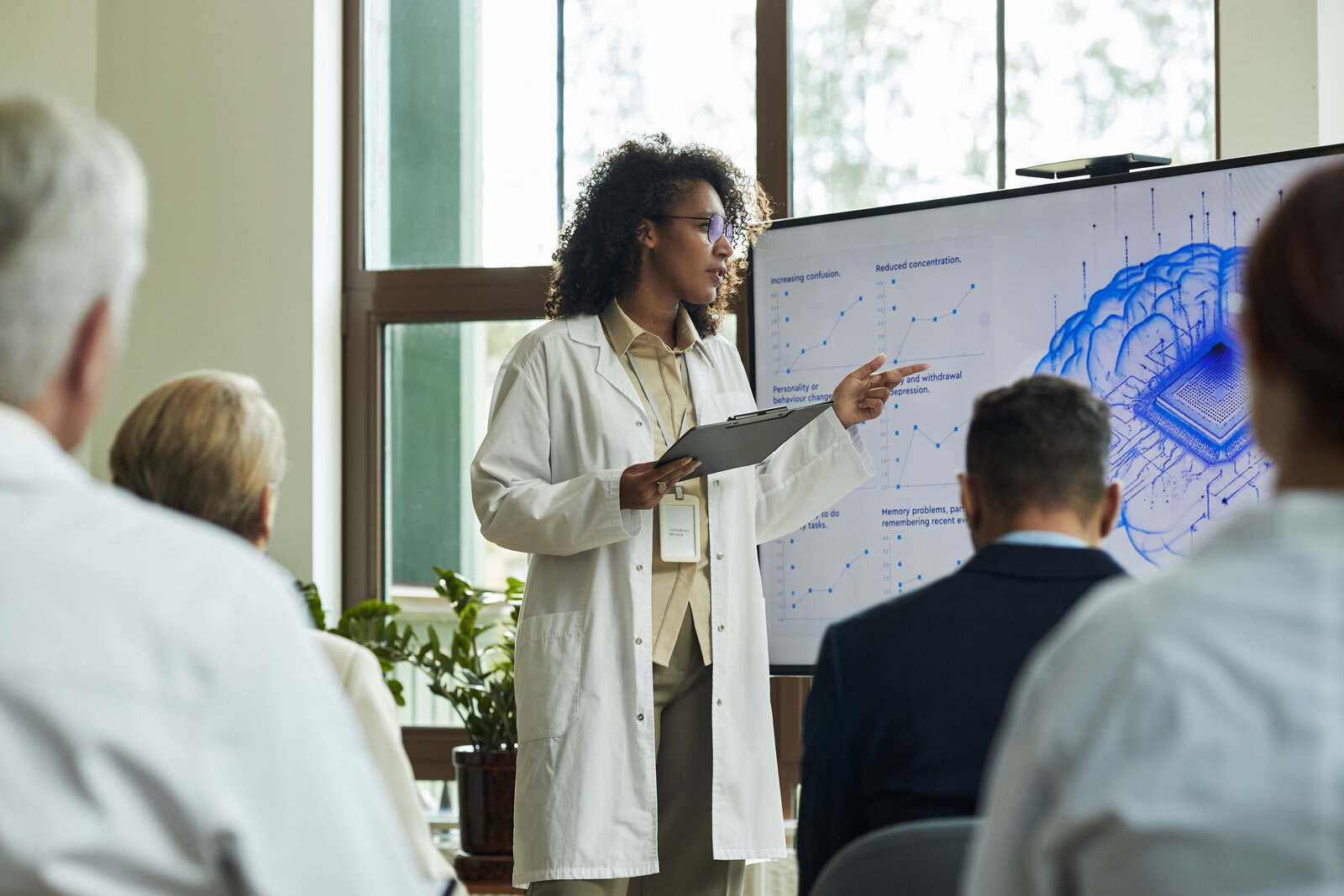 Scientist presenting research on a screen to an audience