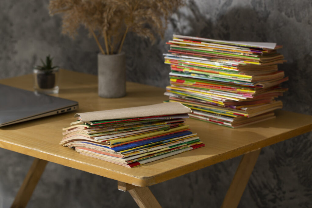 More and more papers Tall stacks of journals and papers on a wooden desk